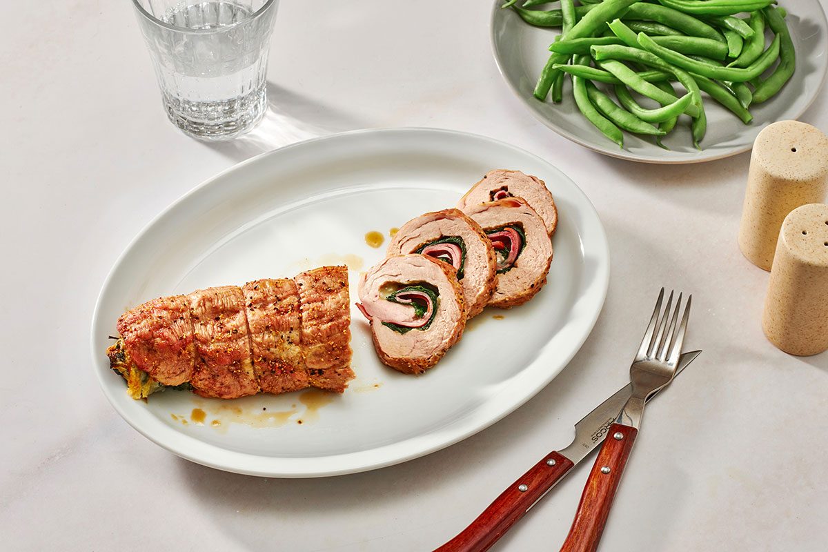Cooked pork tenderloin on a serving platter