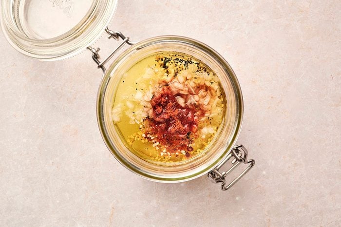 Dressing ingredients for the Strawberry Spinach Salad being combined in an airtight jar recipe by Taste of Home