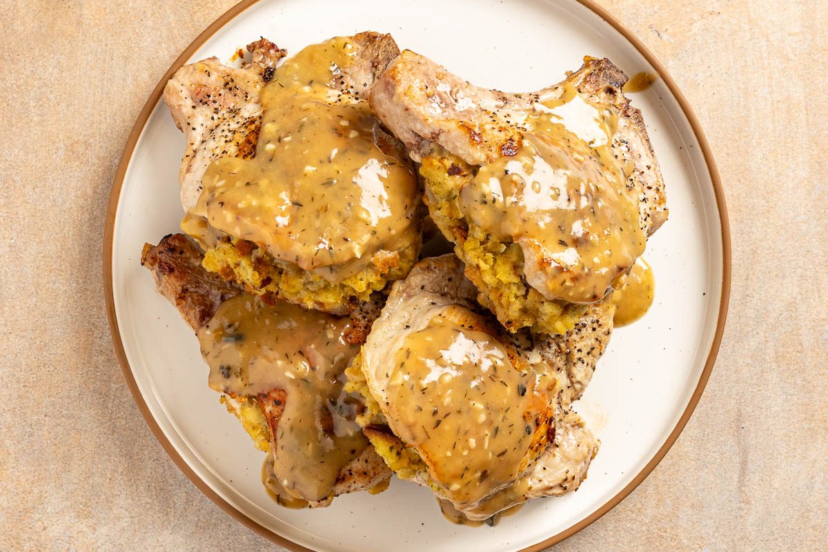 cooked Stuffing Stuffed Pork Chops on a plate with gravy