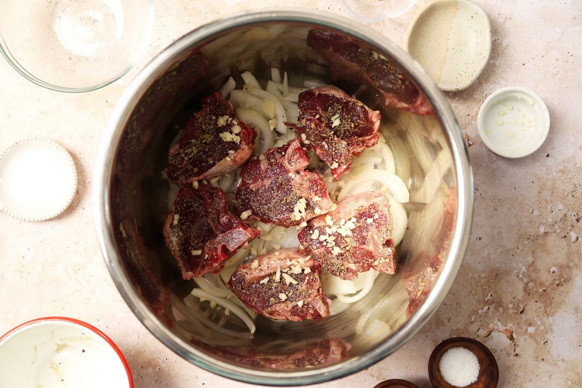 Process of making Taste of Home's Slow Cooker Lamb Chops in a slow cooker on a beige marble surface.