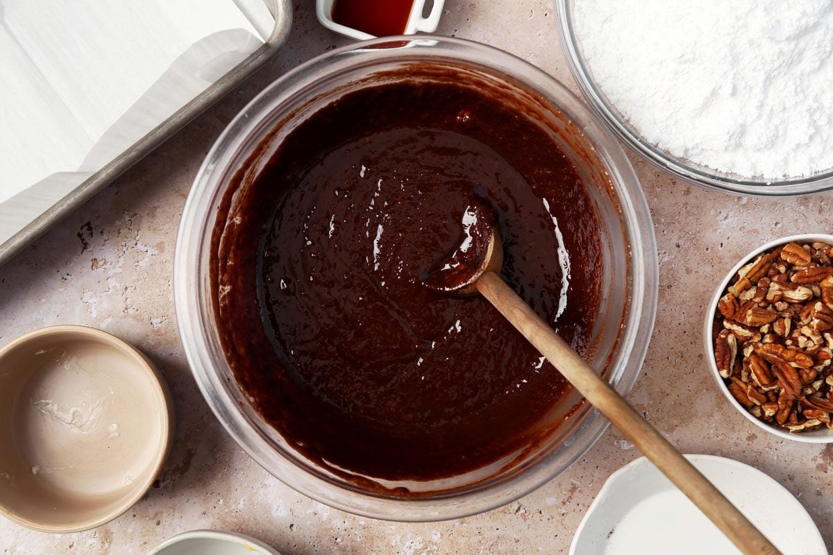 Process of making Taste of Home's Velveeta Fudge in a large mixing bowl on a brown marble surface.
