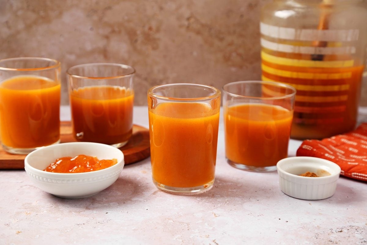 Close up of Taste of Home's Pumpkin Juice served in glasses with an orange towel.