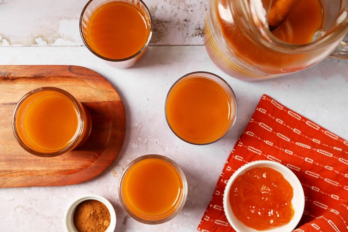 Close up of Taste of Home's Pumpkin Juice served in glasses with an orange towel.