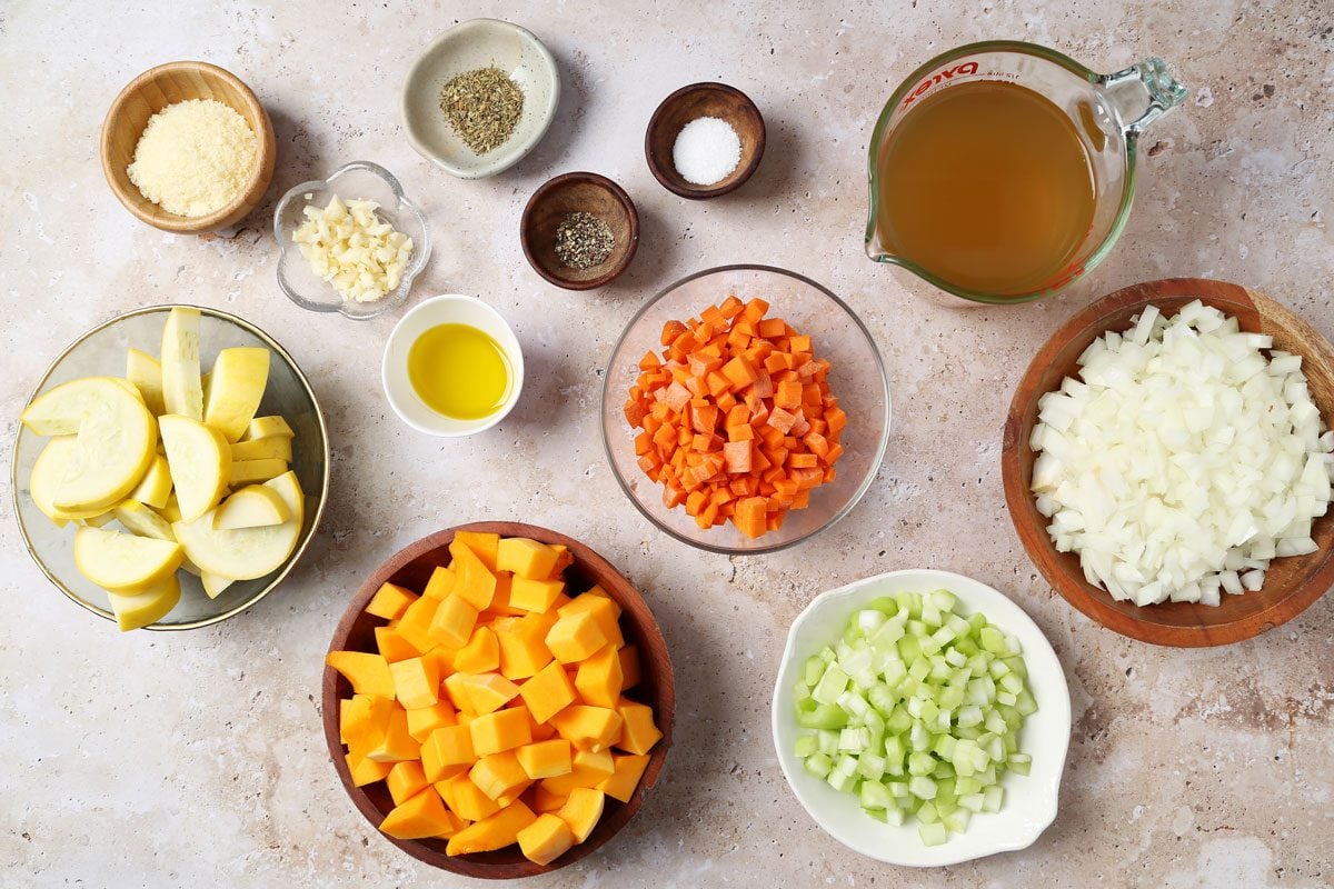 Ingredients for Taste of Home's butternut squash and sweet potato soup laid out in small bowls on a brown marble surface.