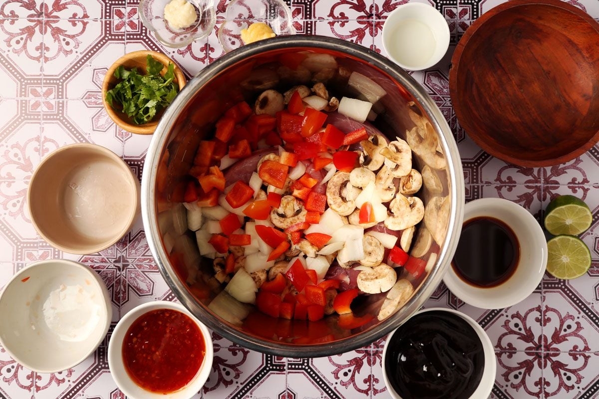 Process of making Taste of Home's Pork Bowl in a pressure cooker on a red and white tiled surface.