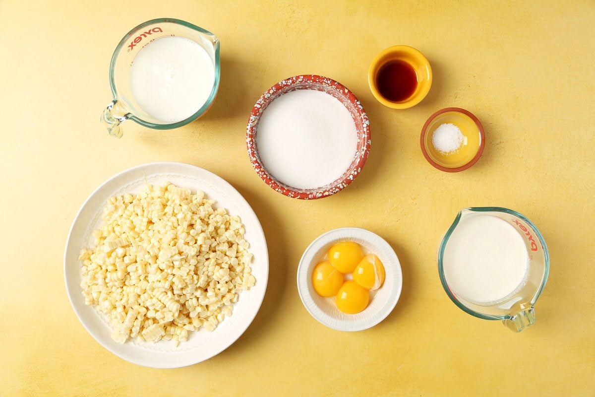 Ingredients for Taste of Home's Corn Ice Cream laid out in small bowls on a yellow surface.