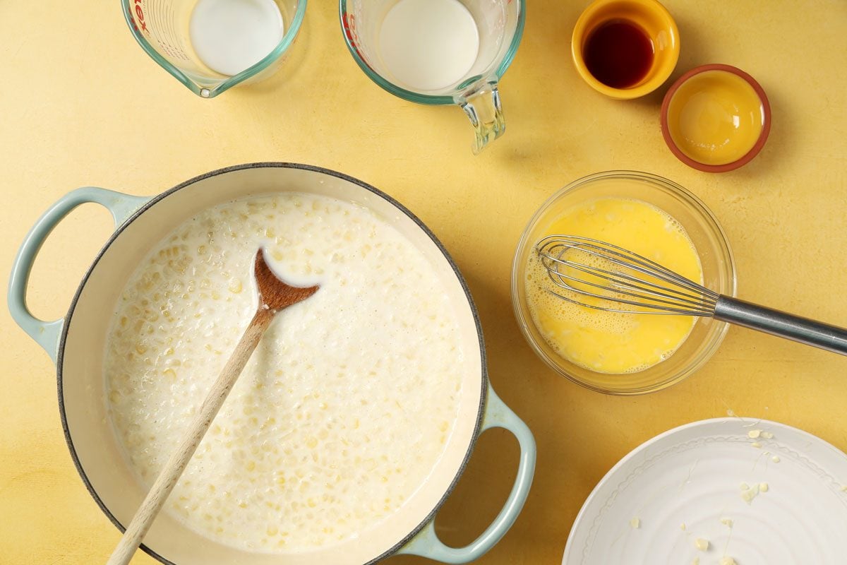 Process of making Taste of Home's Corn Ice Cream in an ice cream maker on a yellow surface.
