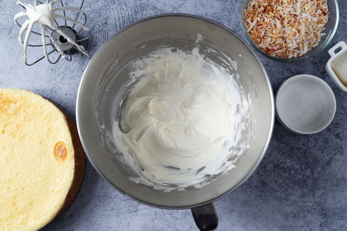Process of making Taste of Home's Coconut Cheesecake on a dark blue surface.