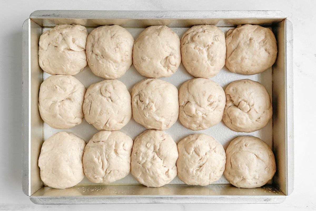 Proofed Taste of Home Whole Wheat Rolls in a metal baking pan