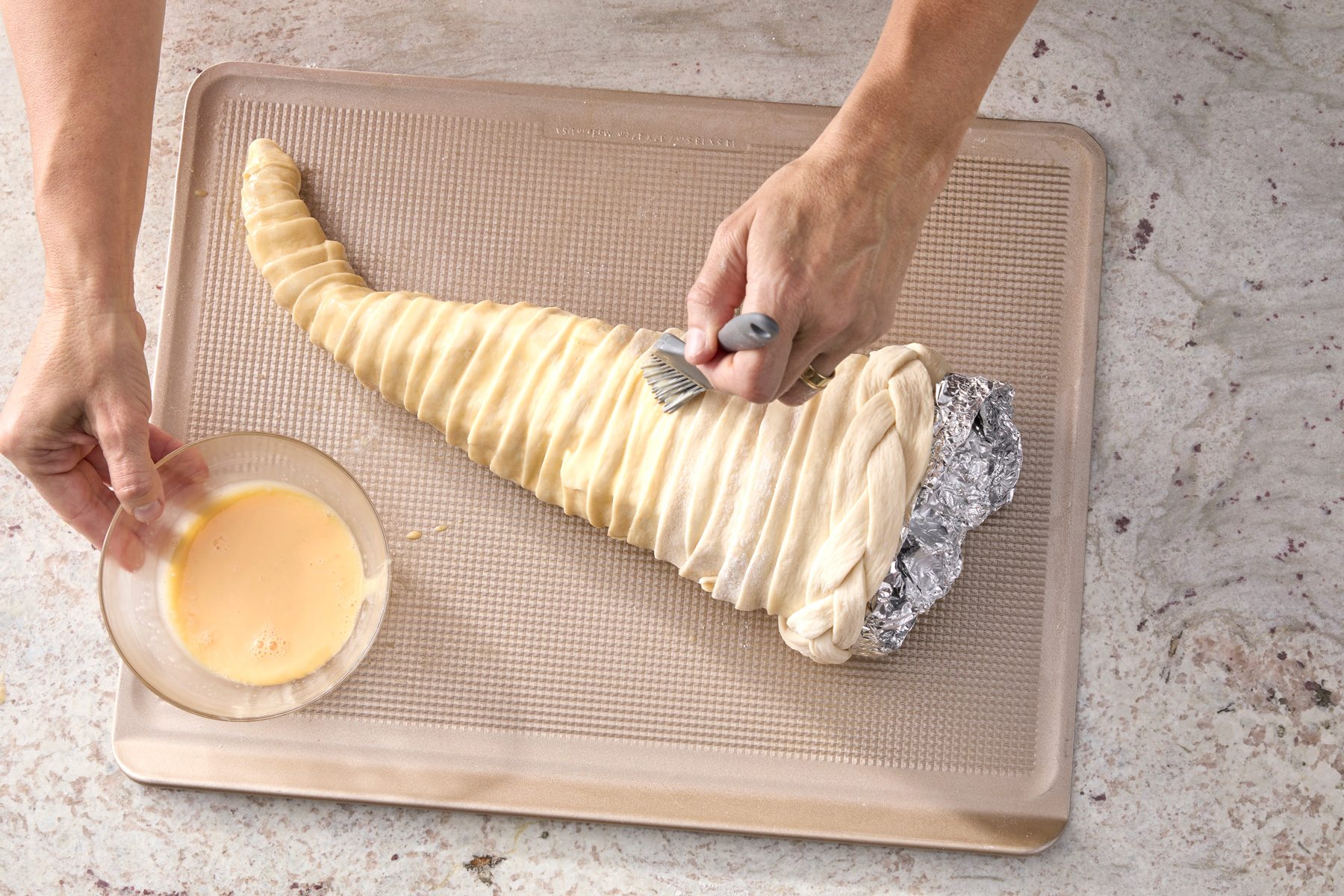 brush egg and cream mix evenly over cornucopia.