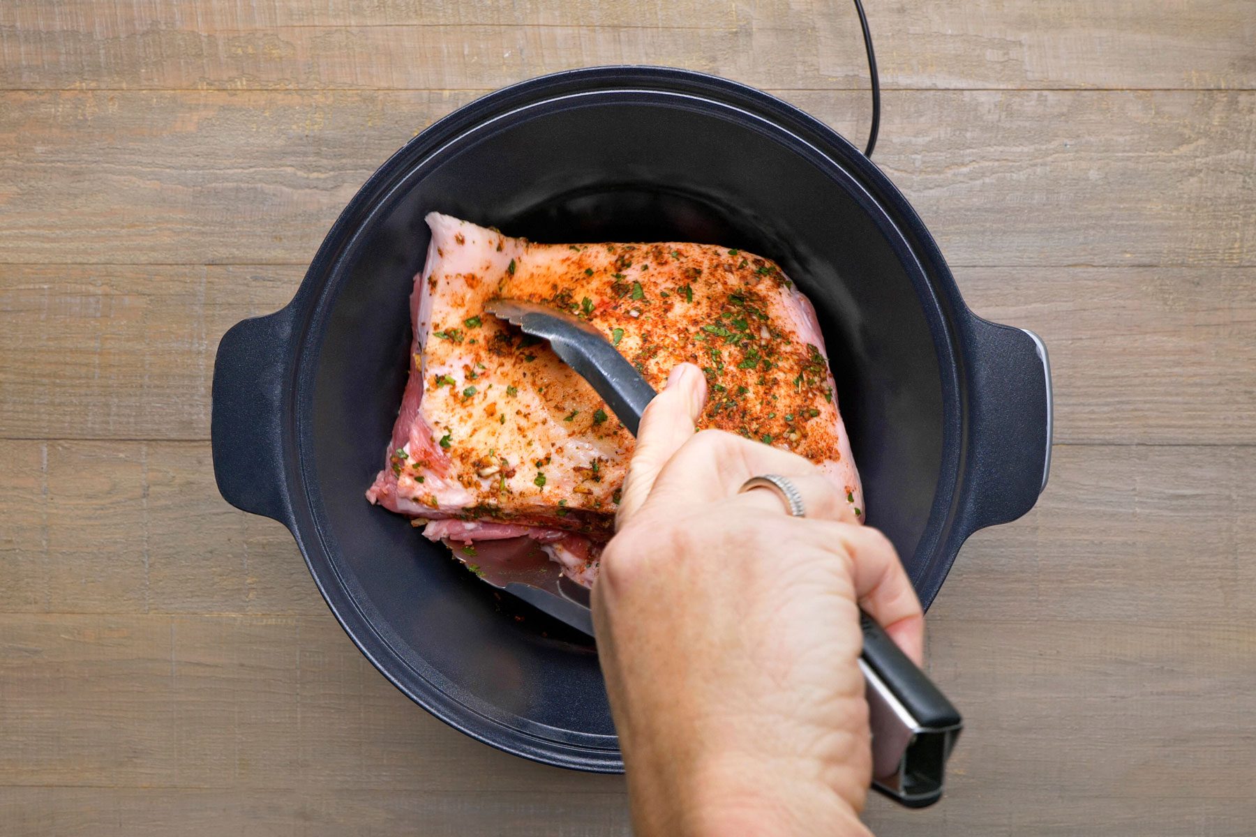 roast cut in half being covered in spice mixture
