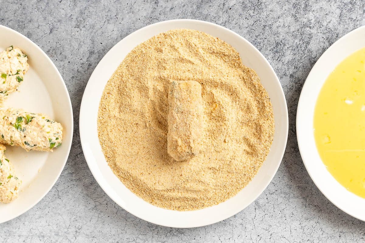 Taste of Home Chicken Croquettes photo of coating the croquettes.