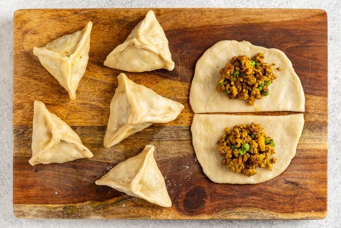 Taste of Home Chicken Samosa photo of shaping the samosas.