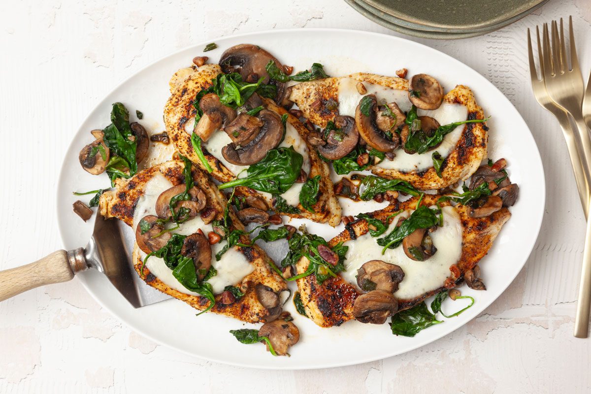 Full yield of Taste of Home Chicken with Spinach and Mushrooms on a white platter