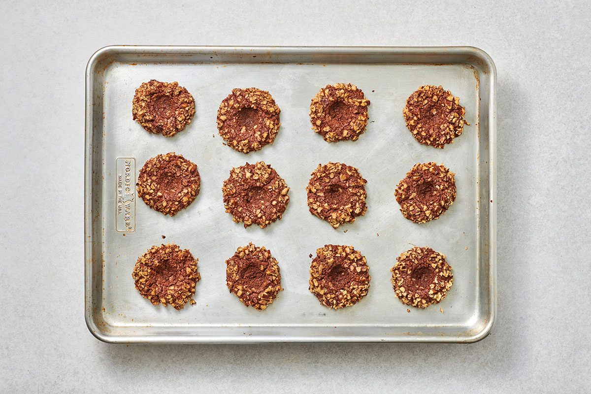 Forming an indentation in the center of each dough ball 