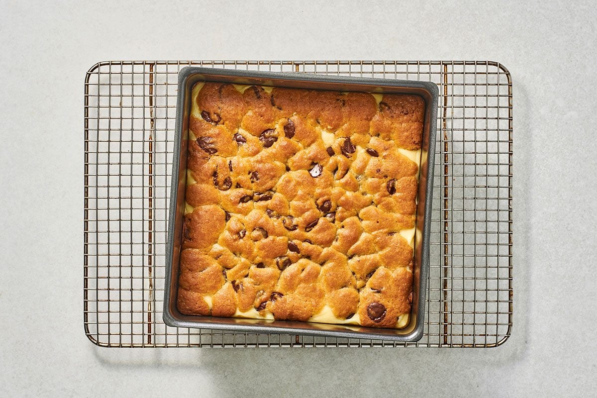 Baked chocolate chip chees bars on a cooling rack
