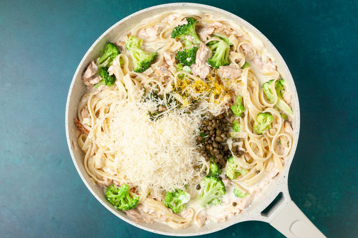 Step 3 of Taste of Home Creamy Salmon Linguine is to add the pasta, broccoli, cream parmesan; lemon and capers