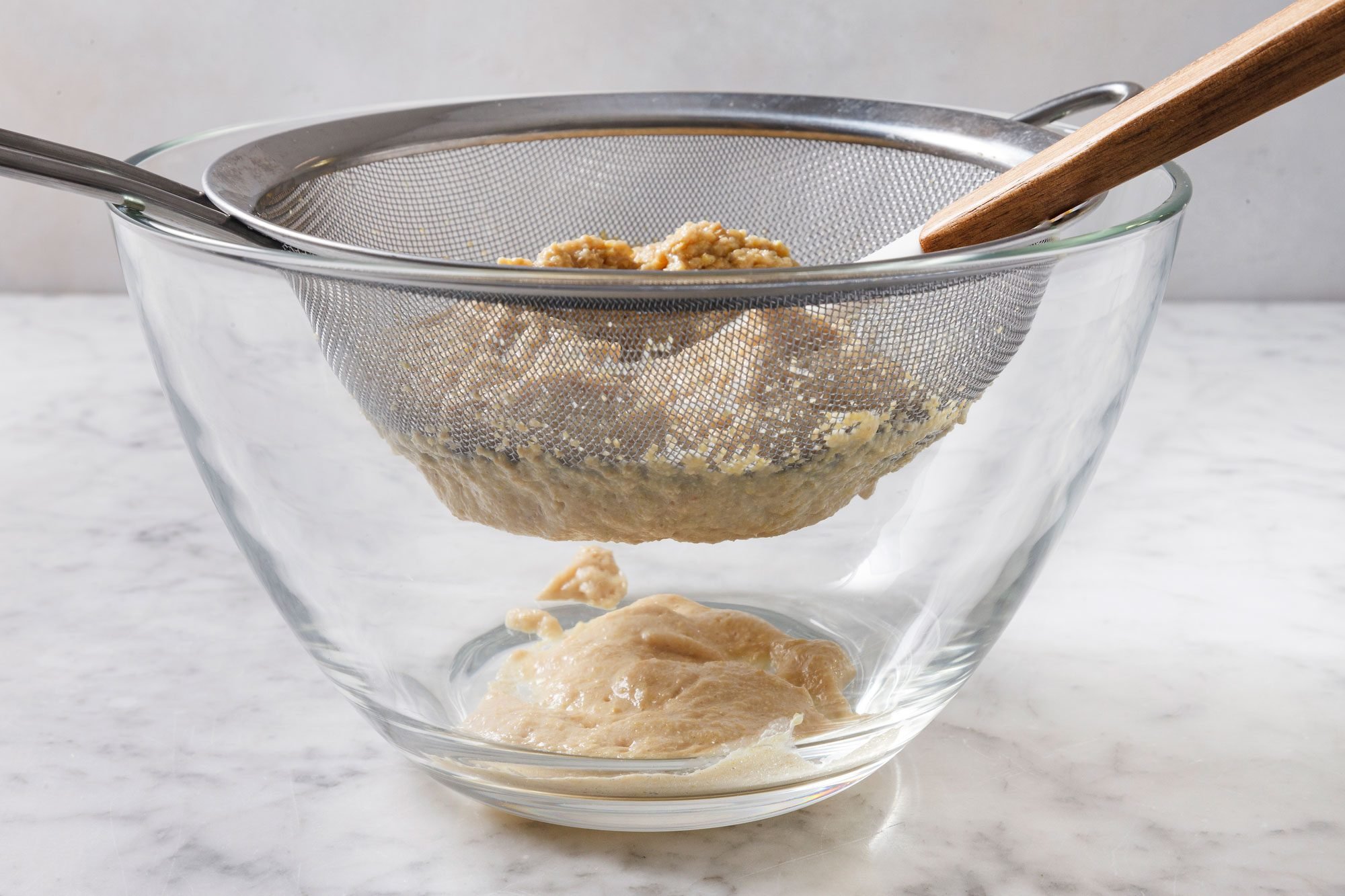 press firmly on the solids with a spoon or spatula to extract as much dijon mustard as possible