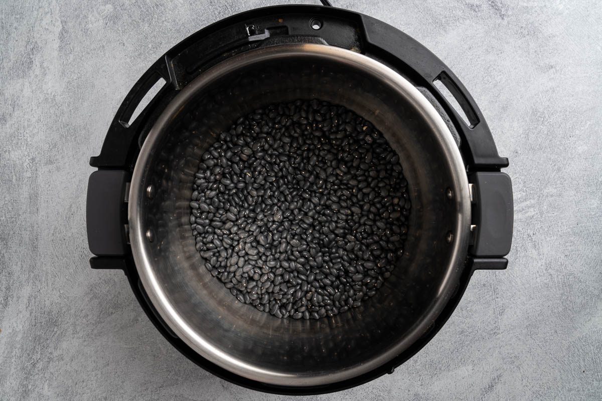 Taste of Home Instant Pot Black Beans recipe photo of the rinsed beans in a pressure cooker.