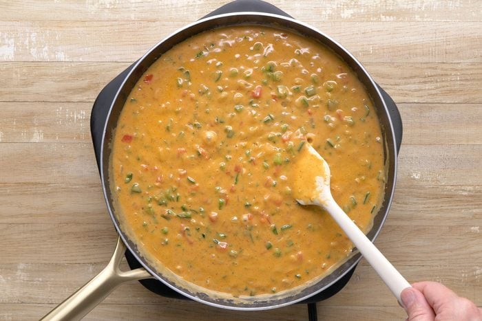 Vegetables, cream, chicken stock and seasonings mixed in a skillet