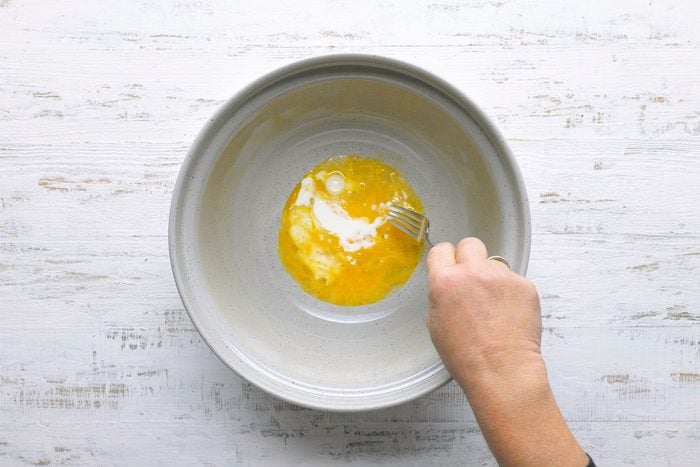 In a large bowl combine eggs and milk with fork