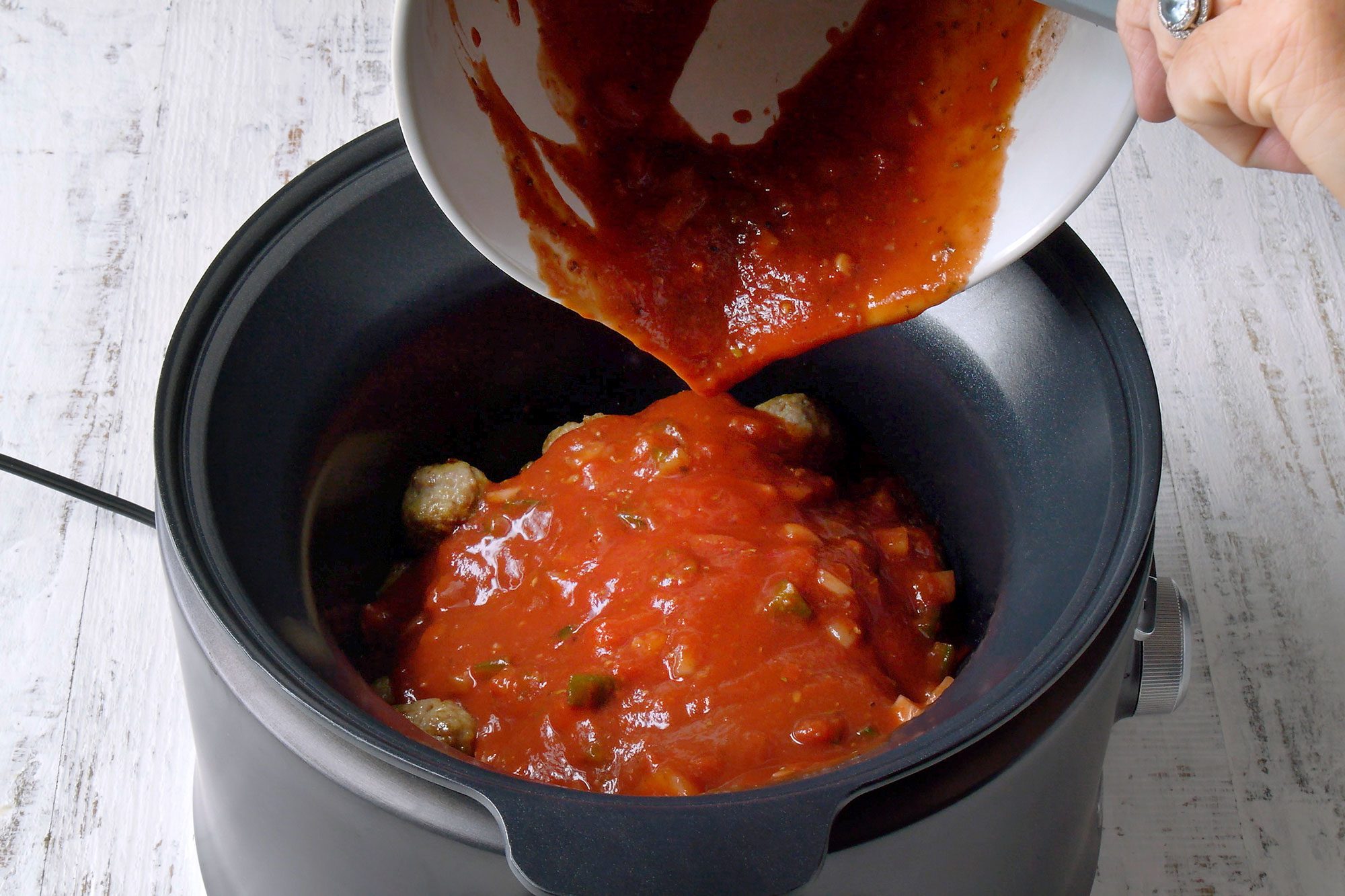 Transfer to a slow cooker, combine the tomato sauce and paste, onion, green pepper, wine, water and seasonings. pour over meatballs cover and cook on low for 4-5 hours