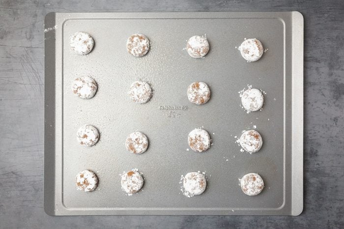 Step 3 of Taste of Home Molasses Crackle Cookies is to roll in powdered sugar, flattena and bake