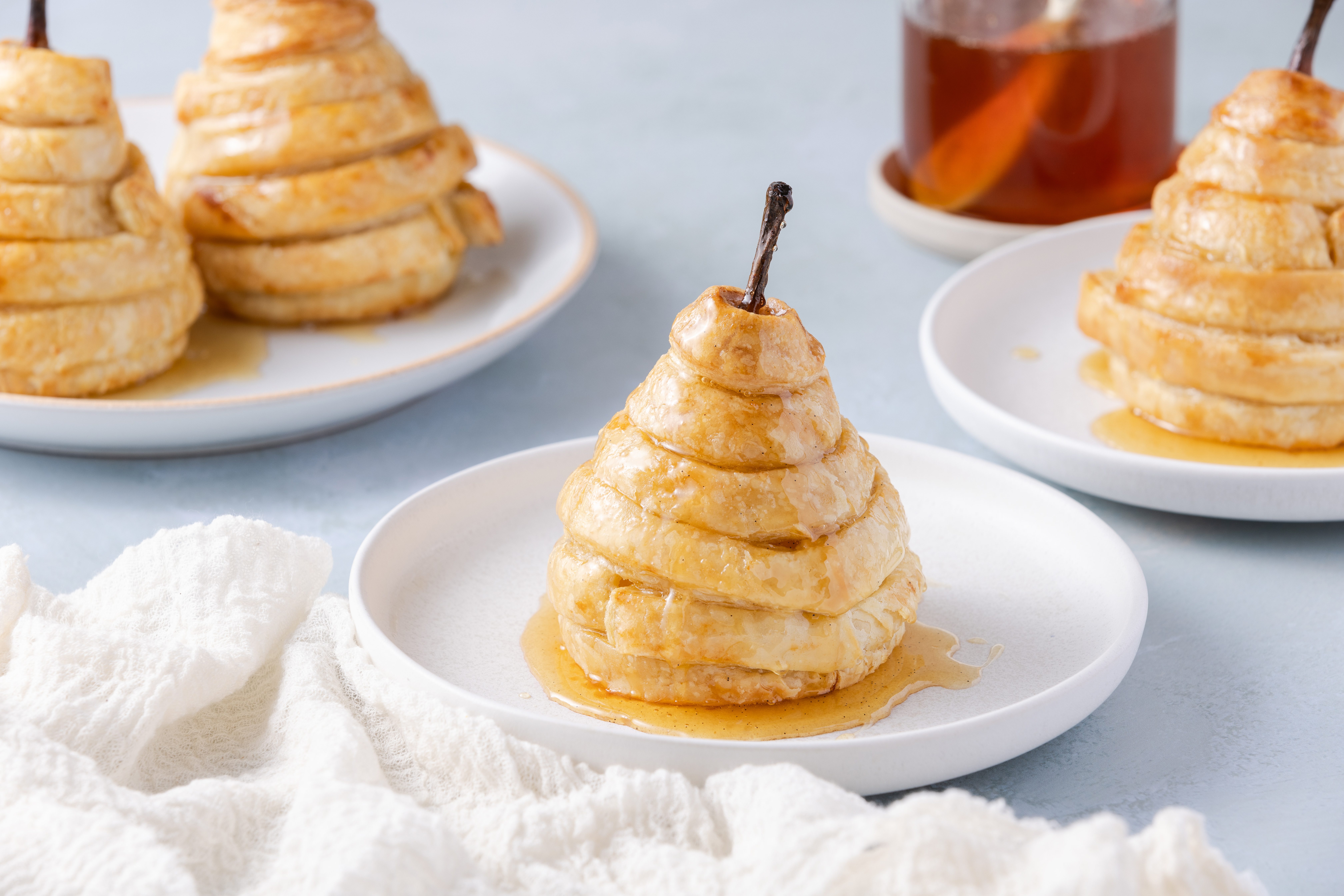 Pears puff pastry ready, drizzled with syrup and served in small plates.
