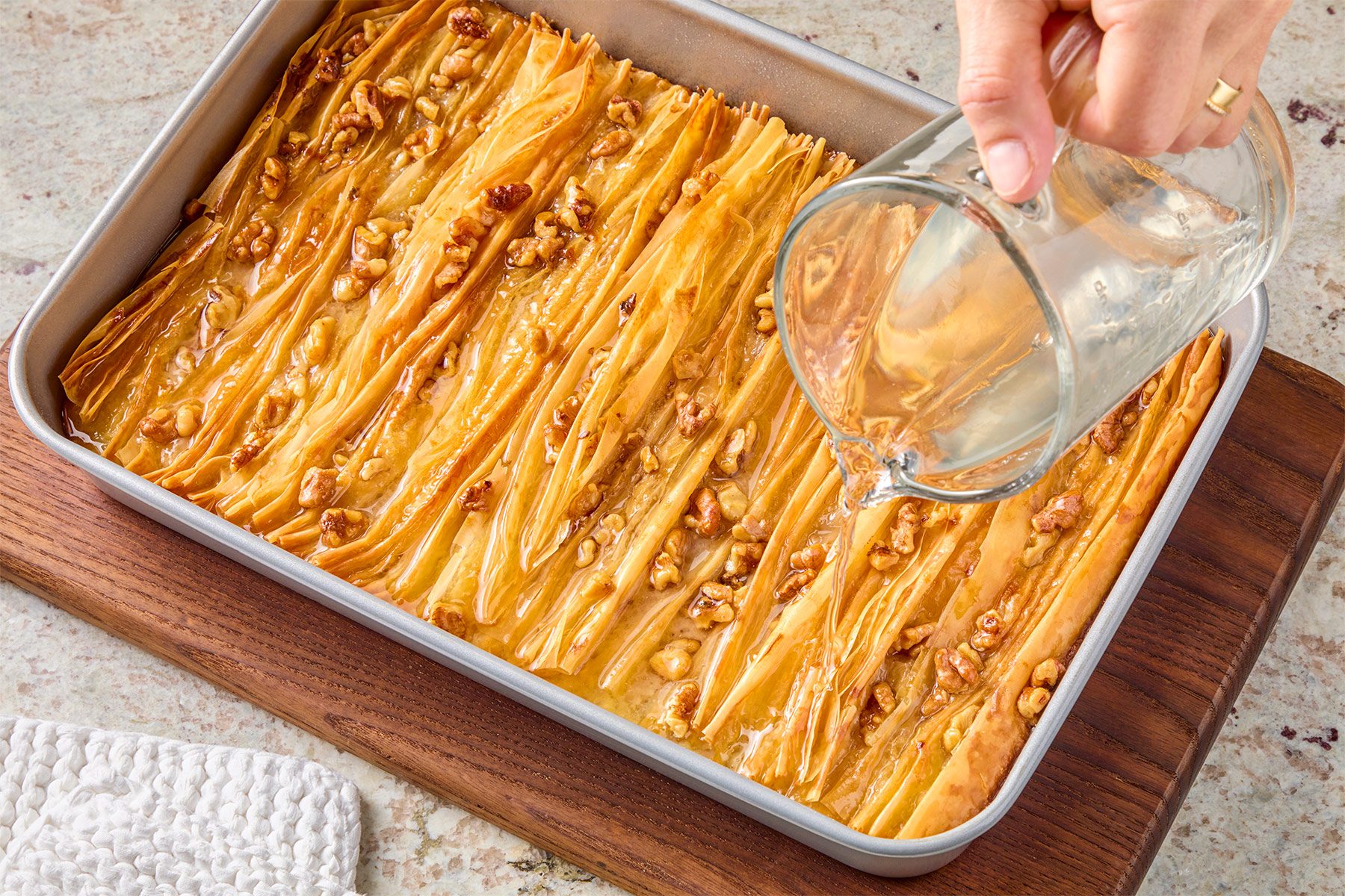 Drizzle simple syrup over warm cake.