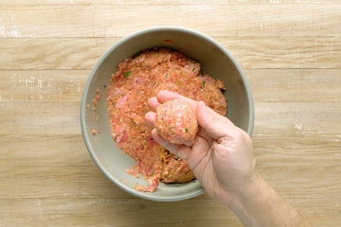 With wet hands, rolling 1/4 cupfuls of the mixture into balls.