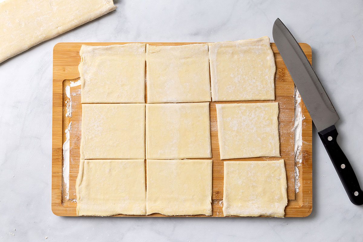 Puff pastry dough rolled out and cut into 9 squares for step two of Puff Pastry Danish recipe for Taste of Home