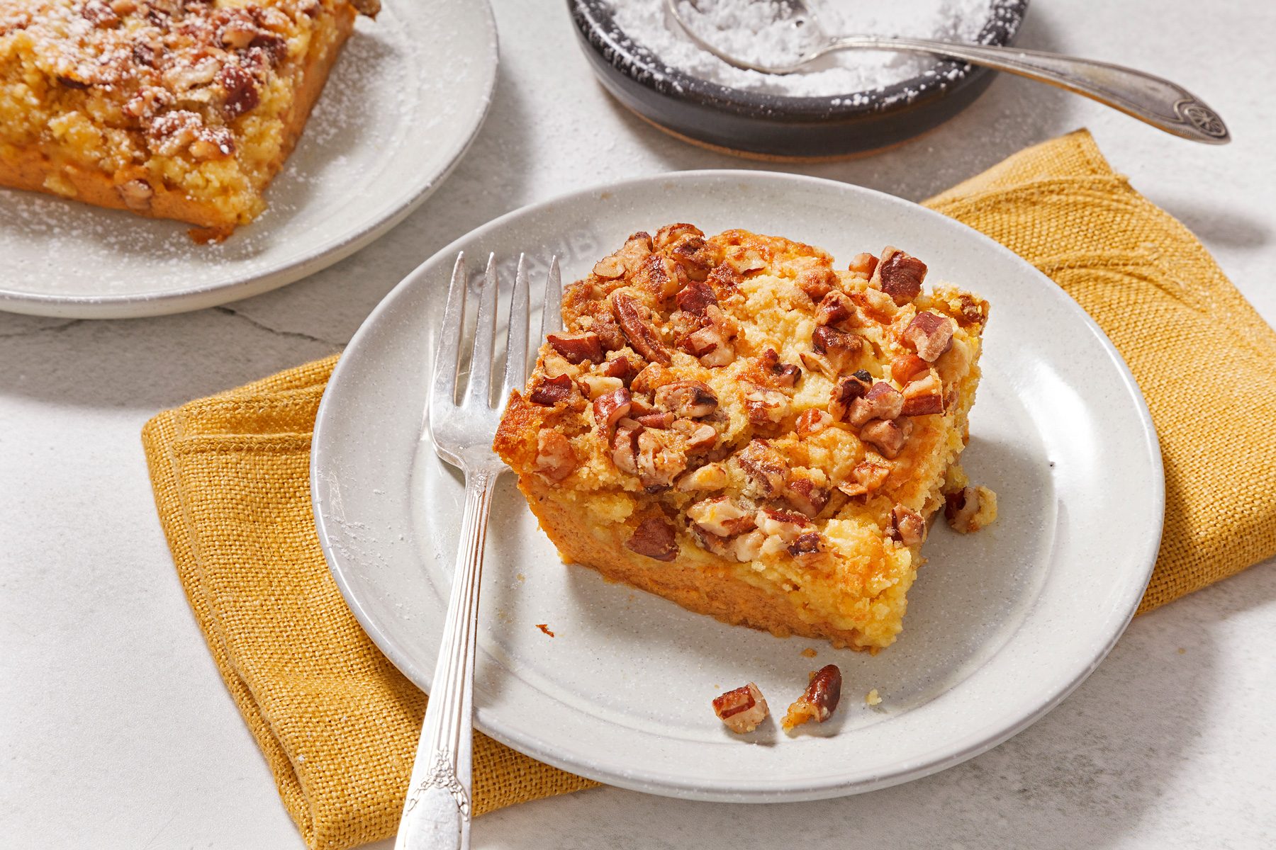 3/4th shot of pumpkin crunch cake slice on a plate.