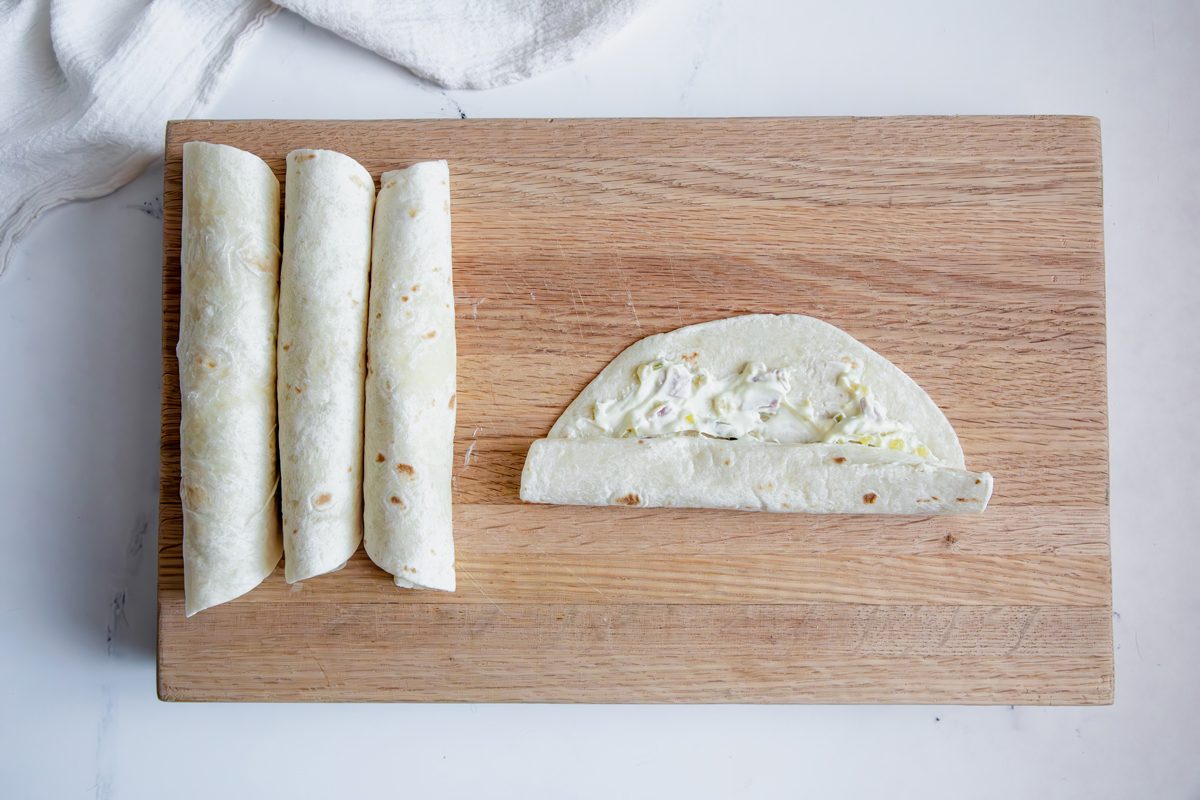 Overhead shot for Taste of Home Salami Roll Ups being rolled into tortillas.