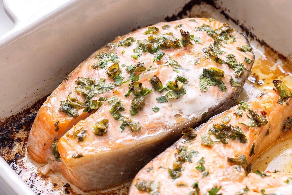 Close up of baked Salmon Steaks in a baking dish for Taste of Home