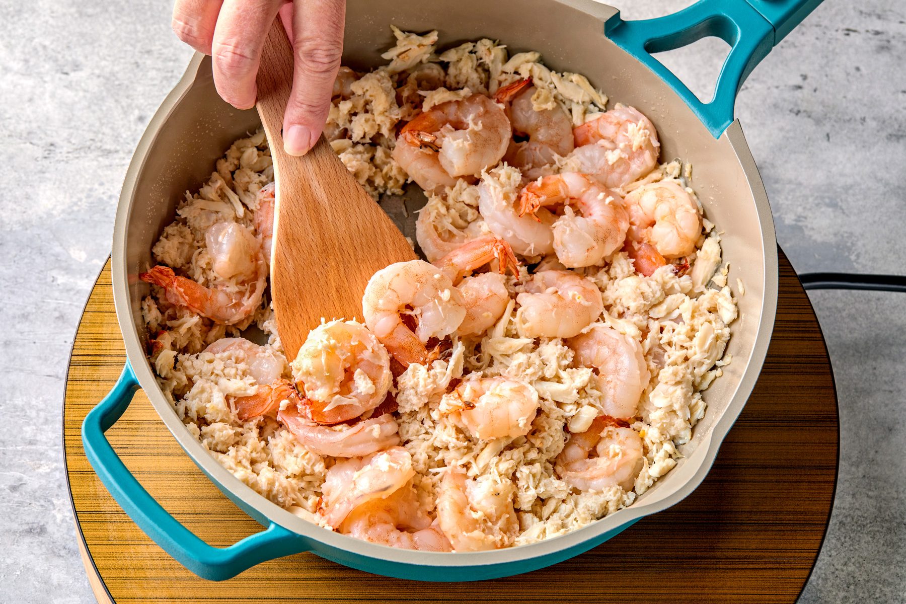 overhead shot of a large skillet, heating 2 tablespoons butter over medium heat cooking shrimp