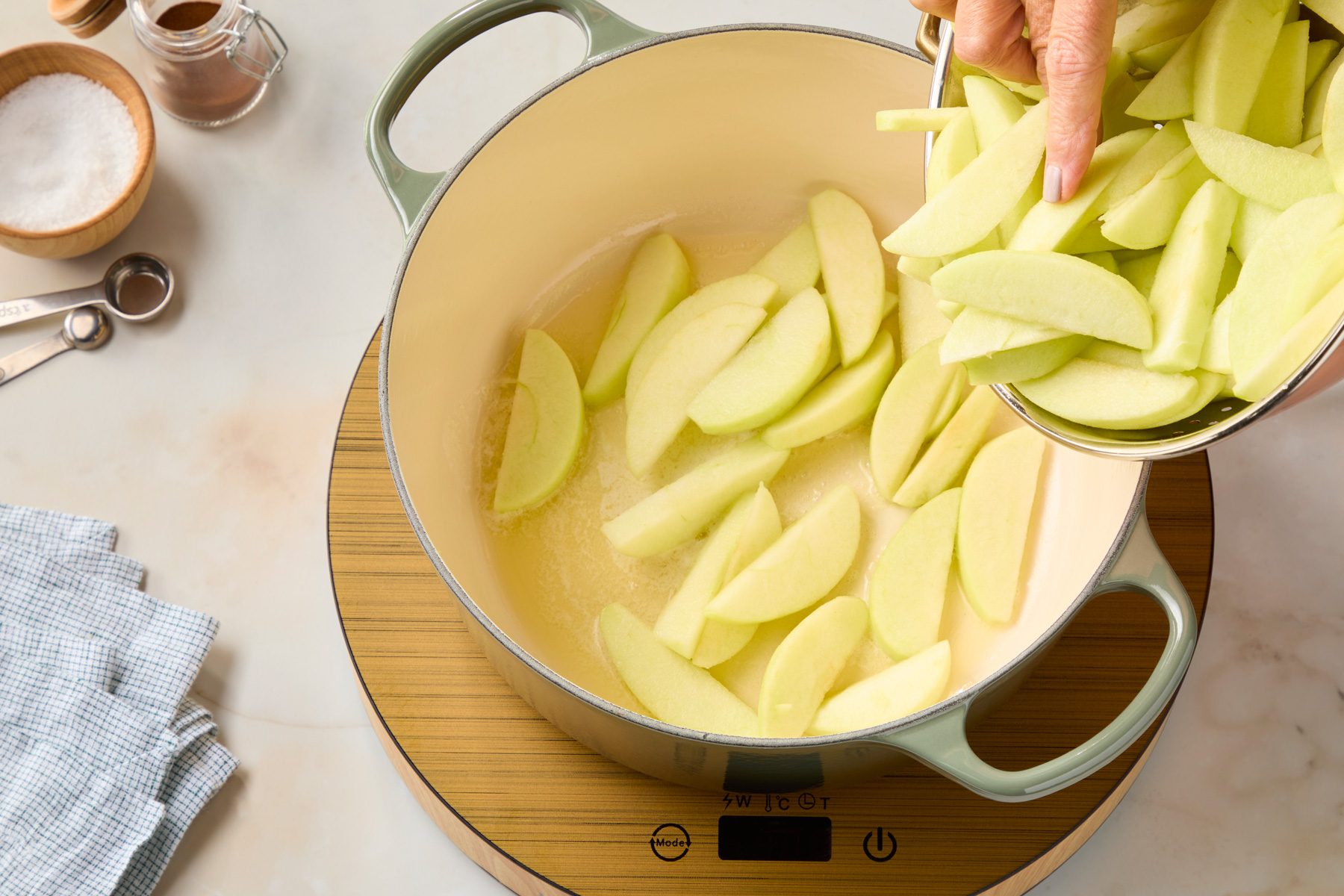 Heat butter in a stock pot to medium heat. Add apples.