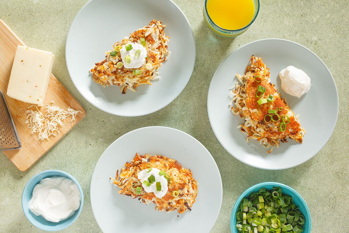 Stuffed Hash browns plated with sour cream and green onions