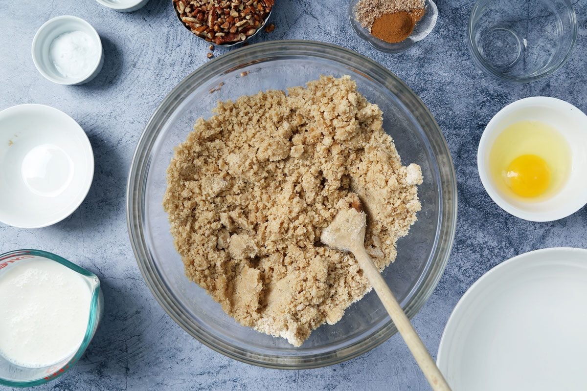 Process of making Taste of Home's Buttermilk Coffee Cake cooling on a wire rack on a light blue surface.