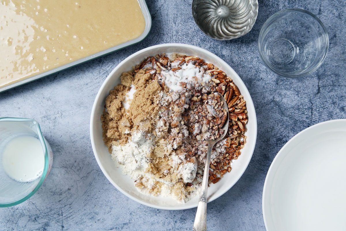 Process of making Taste of Home's Buttermilk Coffee Cake cooling on a wire rack on a light blue surface.