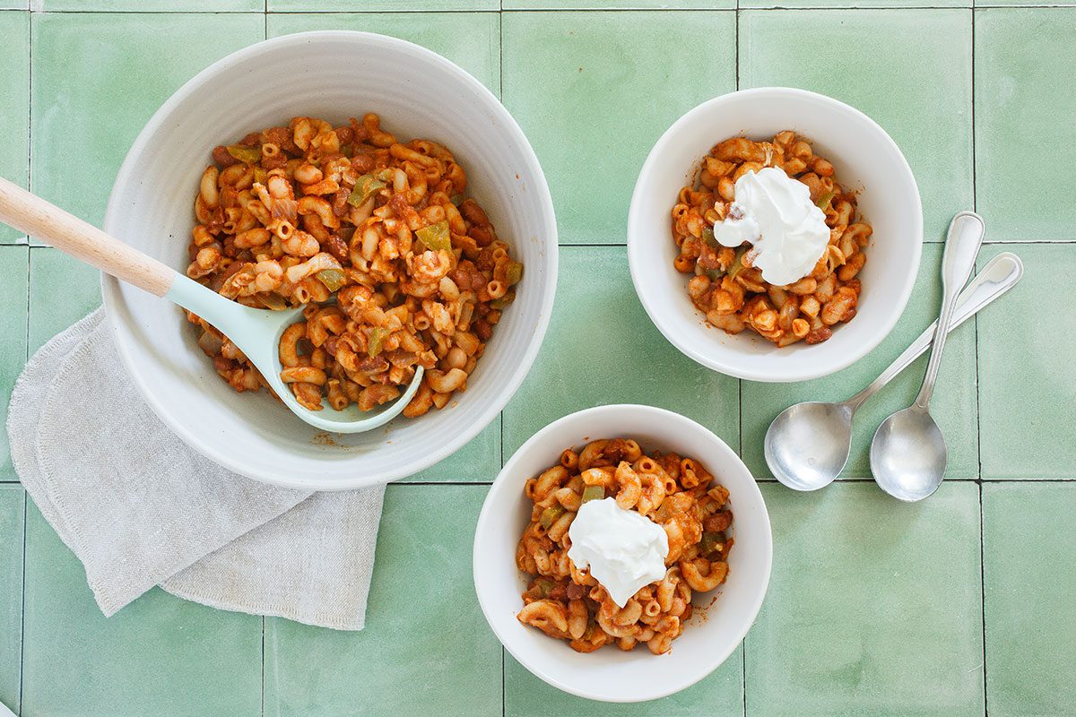 Veggie Chili with sour cream in white bowls