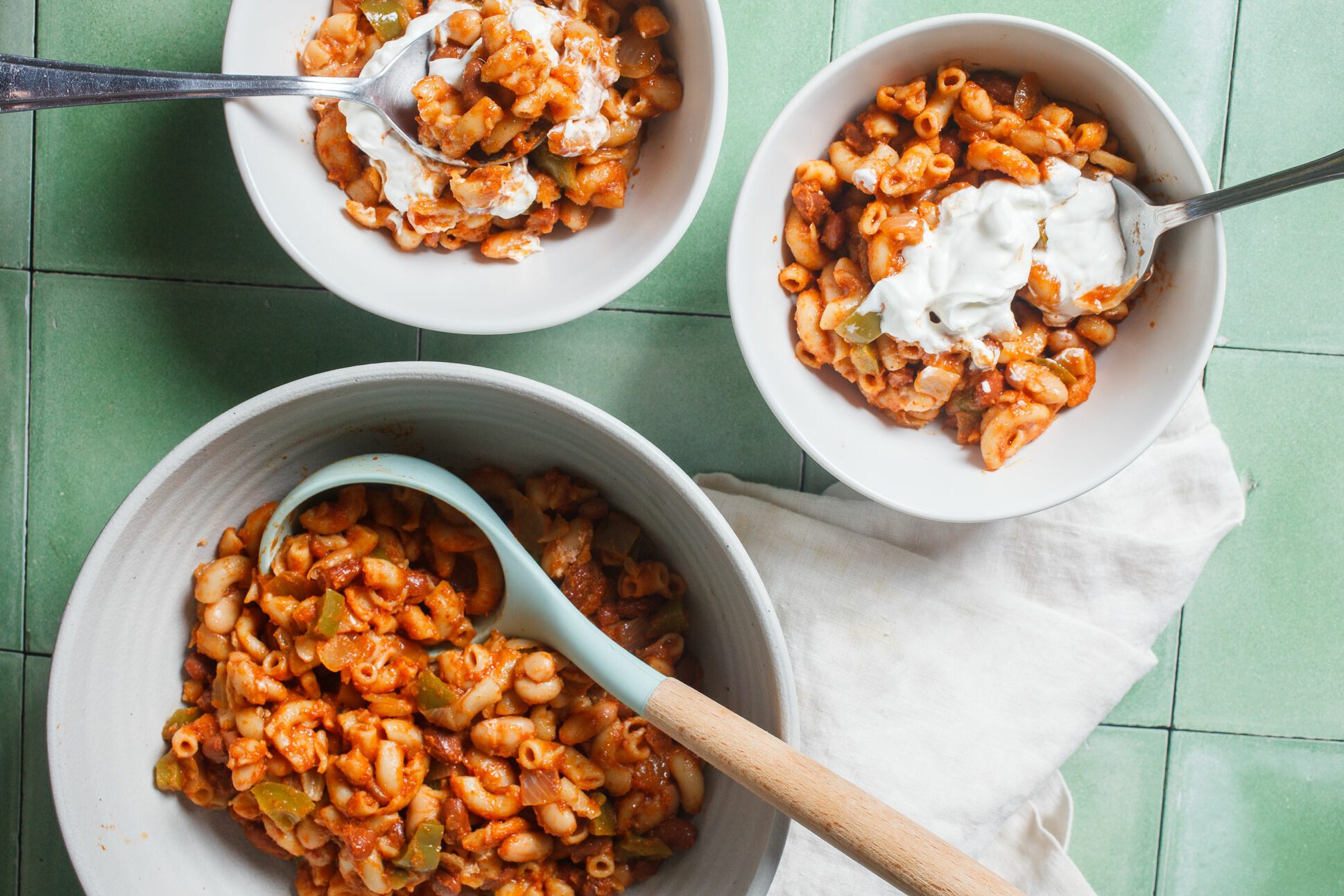 Veggie Chili with sour cream in white bowls