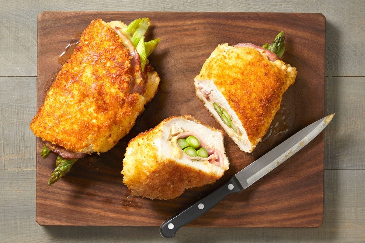 overhead shot of Asparagus-Stuffed Chicken Rolls on a wooden surface