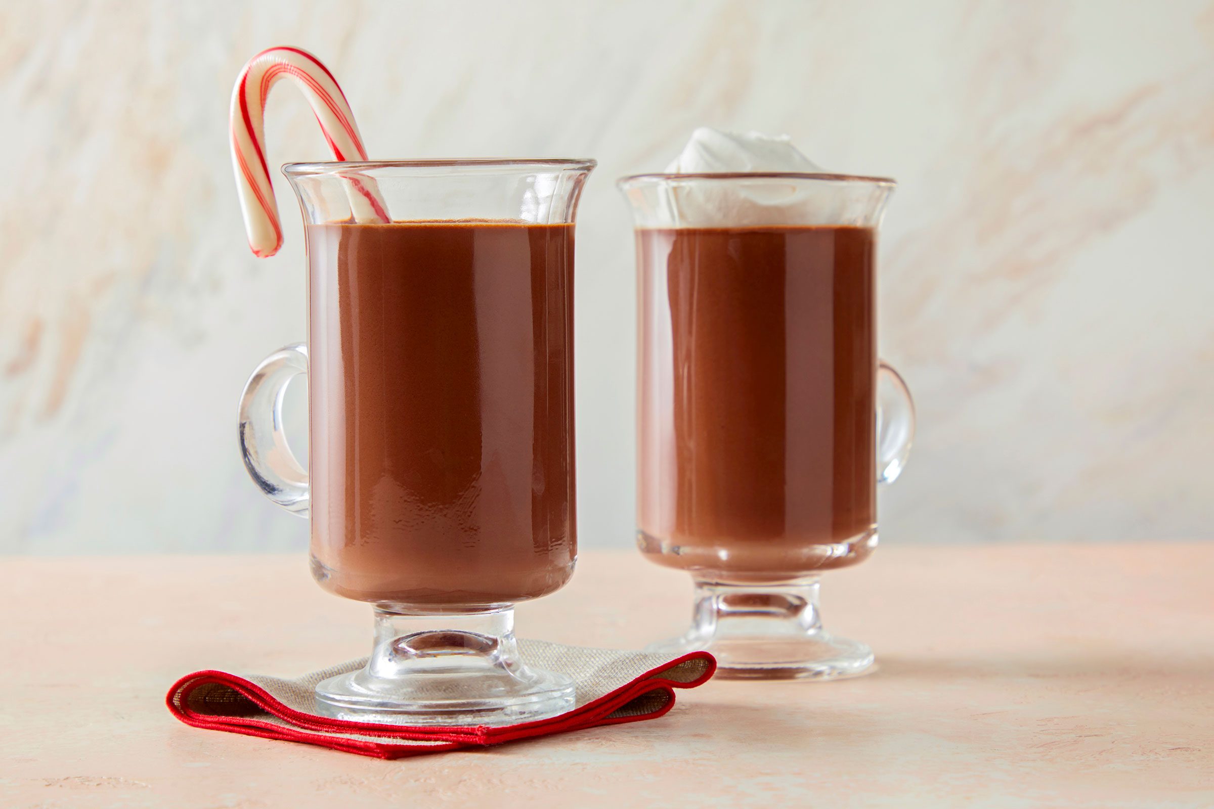 Rich Peppermint Hot Chocolate served in two glasses with ice cream topping