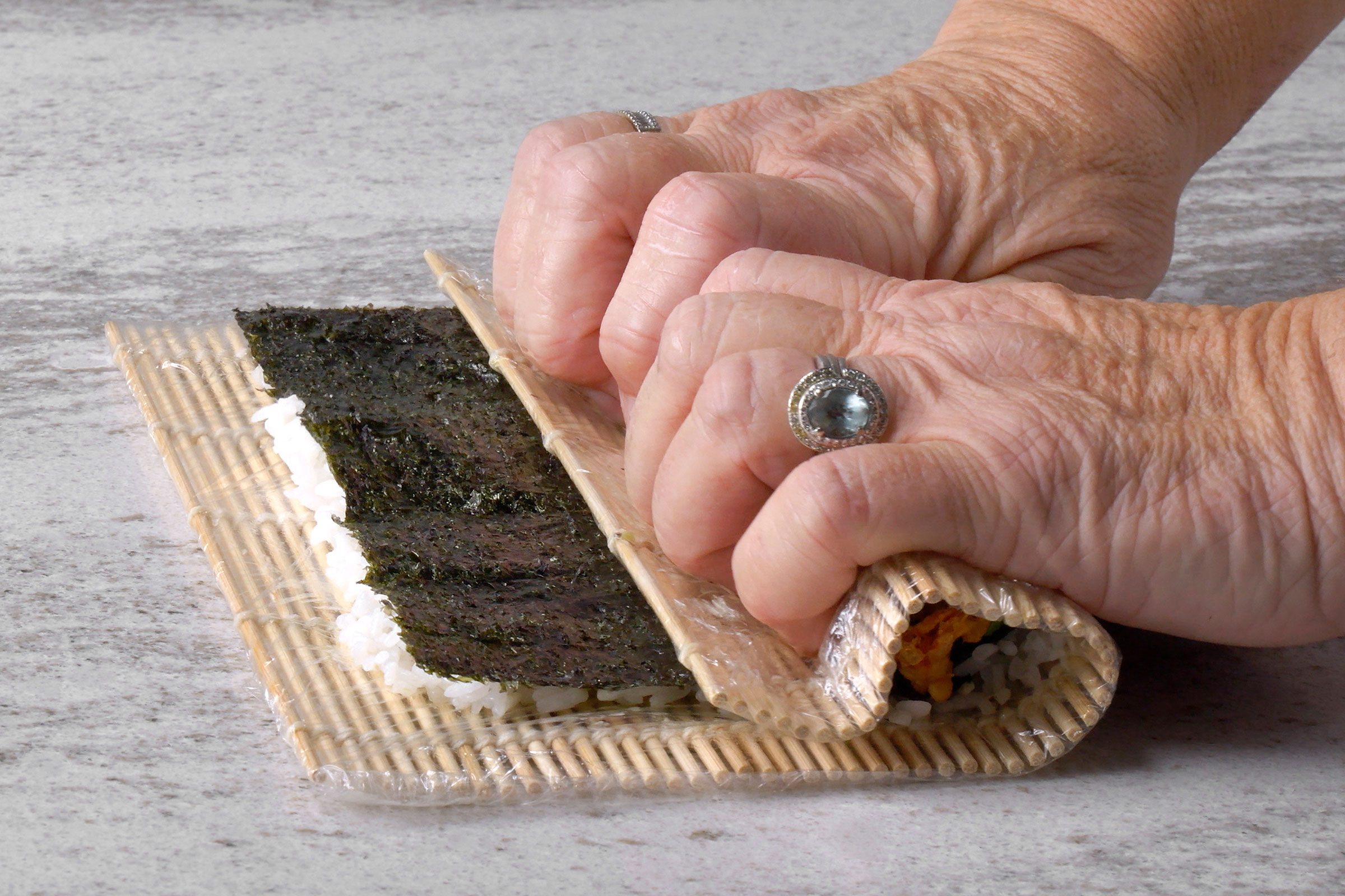 Nori sheet and sushi rice inside the sushi mat