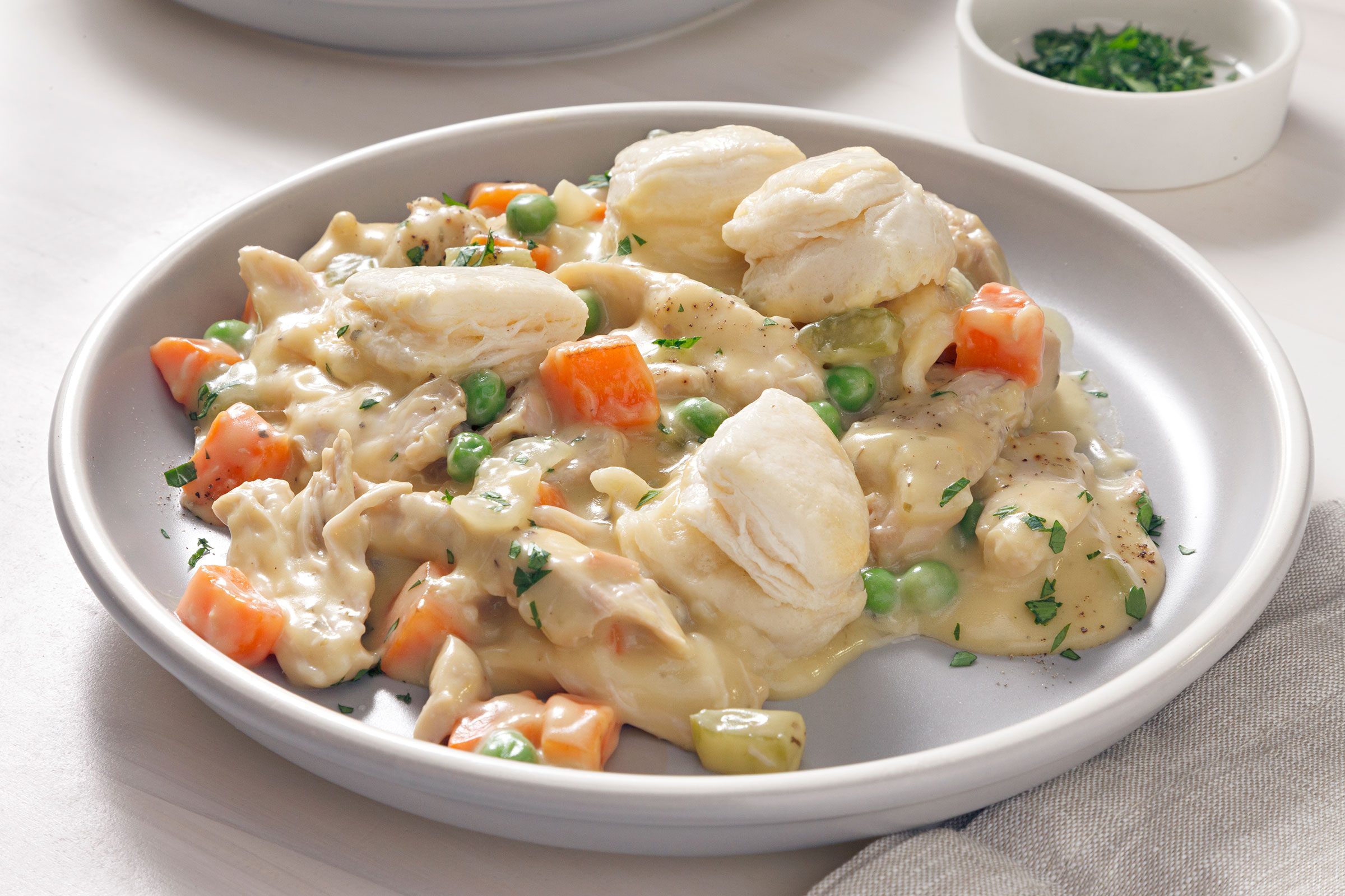 Slow Cooker Chicken And Dumplings served on a white plate