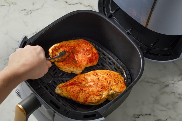 Cooking and flipping chicken breasts in air fryer
