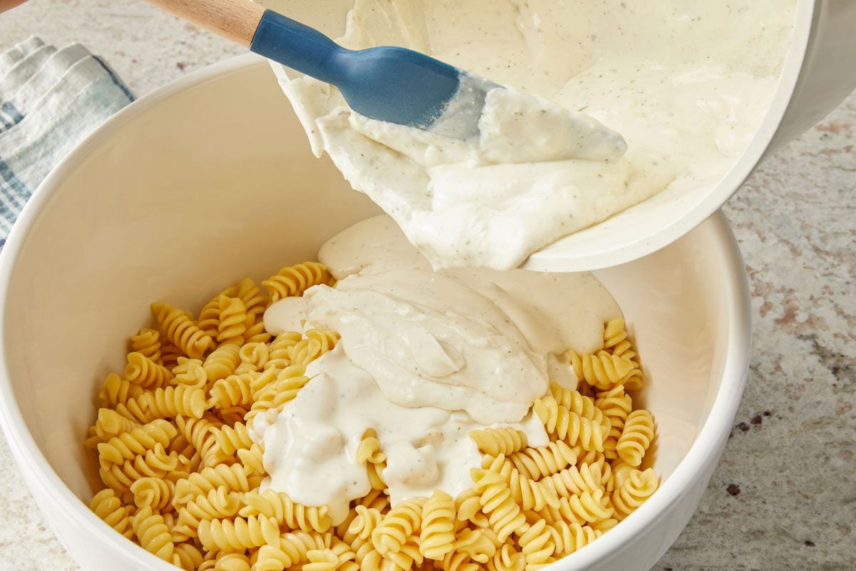 Cook and stir over medium heat until cream cheese is melted; pour over pasta