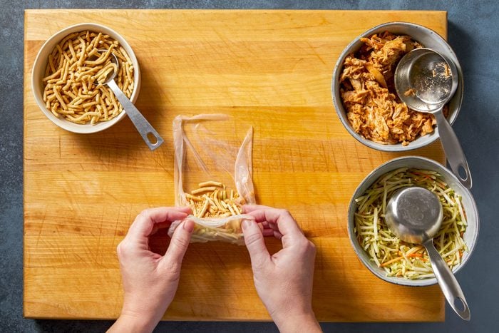 Layer 1/4 cup coleslaw, 1/3 cup chicken mixture and 1 tablespoon noodles across bottom third of wrapper. Fold in both sides of wrapper; fold bottom over filling, then roll up tightly.