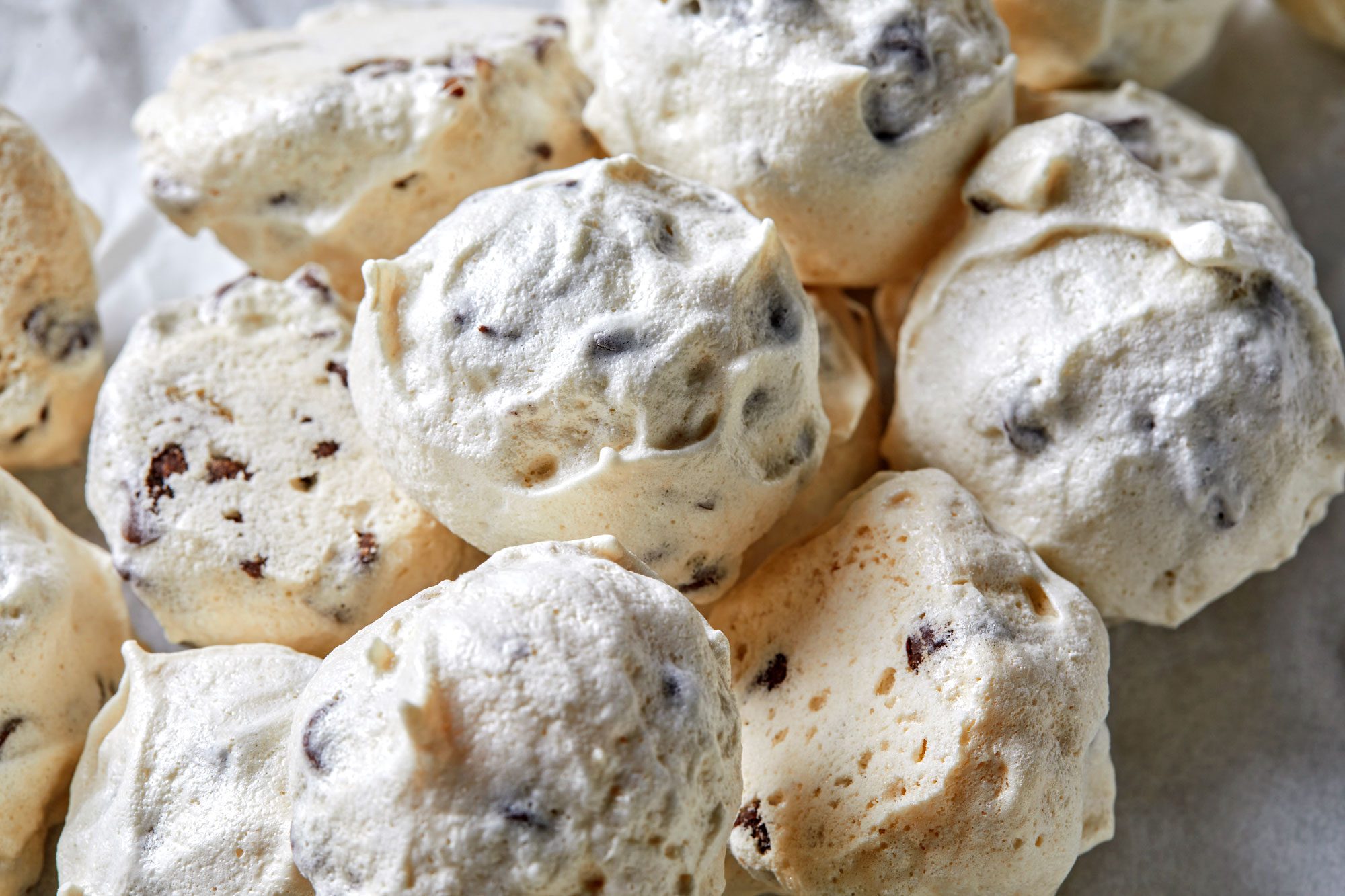 A close-up of Forgotten Cookies reveals their chocolate chip meringue magic, boasting a light, airy texture.