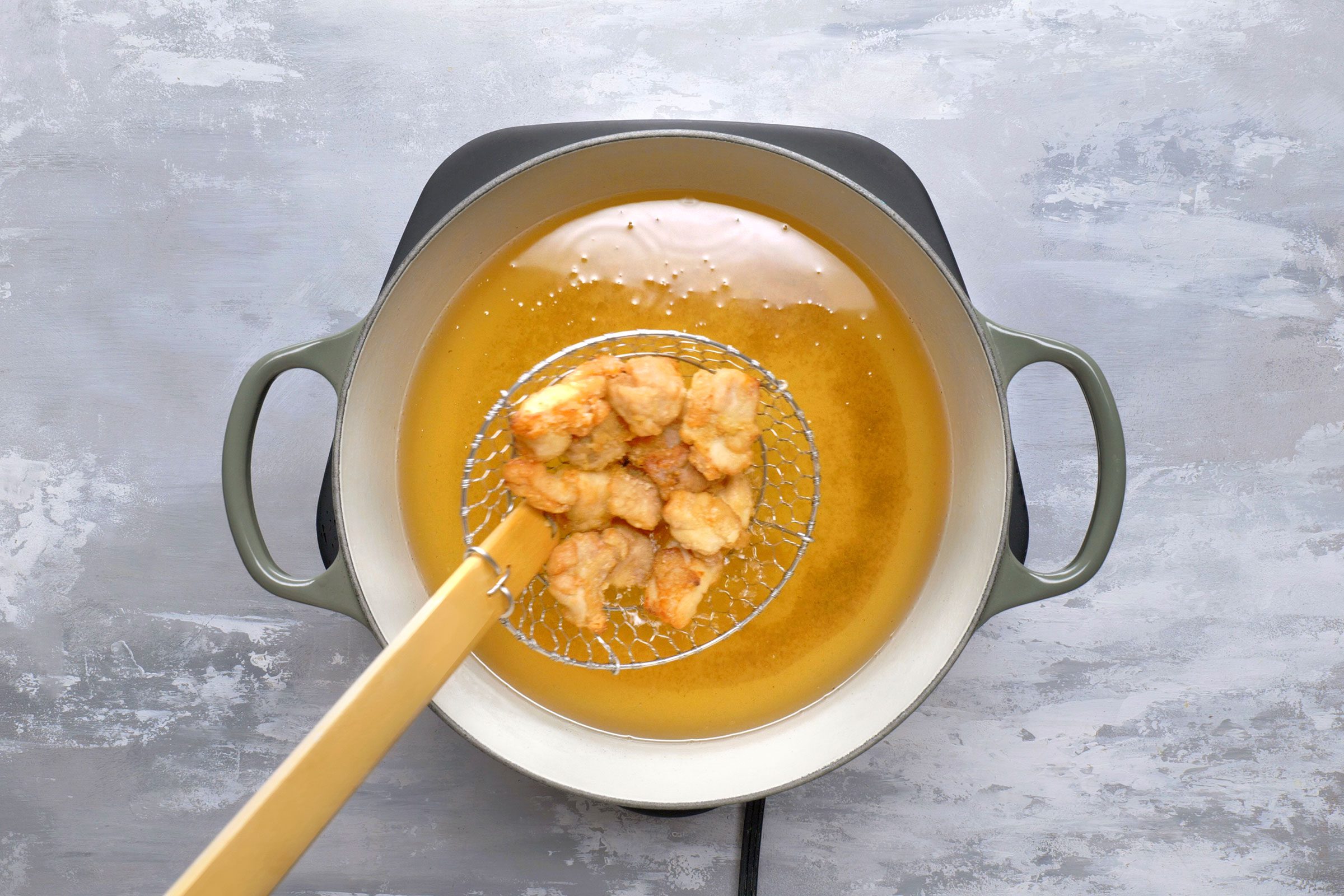 Re frying of marinated chicken pieces in hot oil